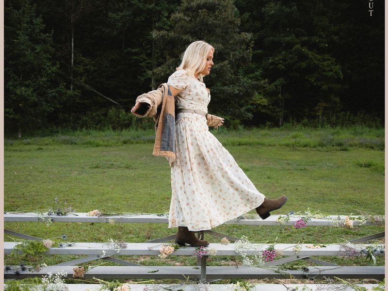 MaRynn walking on bleachers covered in flowers